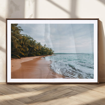 Framed canvas of a tropical beach with palm trees and soft waves, ideal for coastal escape or serene nature-inspired home decor.