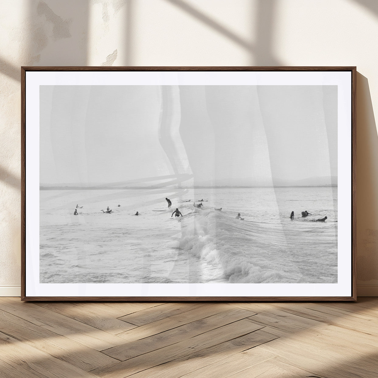Monochrome photo of surfers riding and waiting on ocean waves, ideal for surf-themed or coastal energy wall decor.