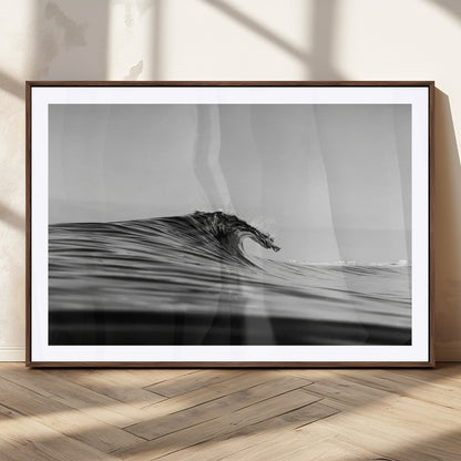 Striking black and white photo of a curling wave, ideal for modern coastal or minimalist wall decor settings.