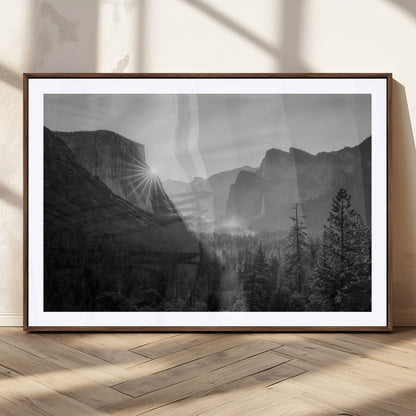 Black and white landscape of Yosemite with sun rays peeking over El Capitan, ideal for moody nature or modern rustic decor.