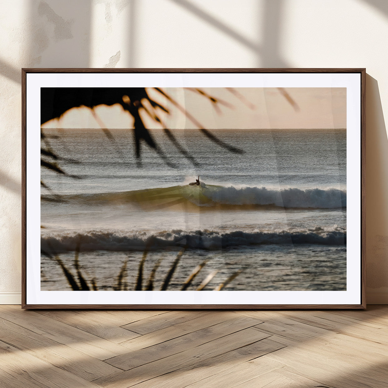 Photo of a surfer riding a golden hour wave at sunset, with tropical tones and dreamy light, perfect for tropical boho or coastal home decor.