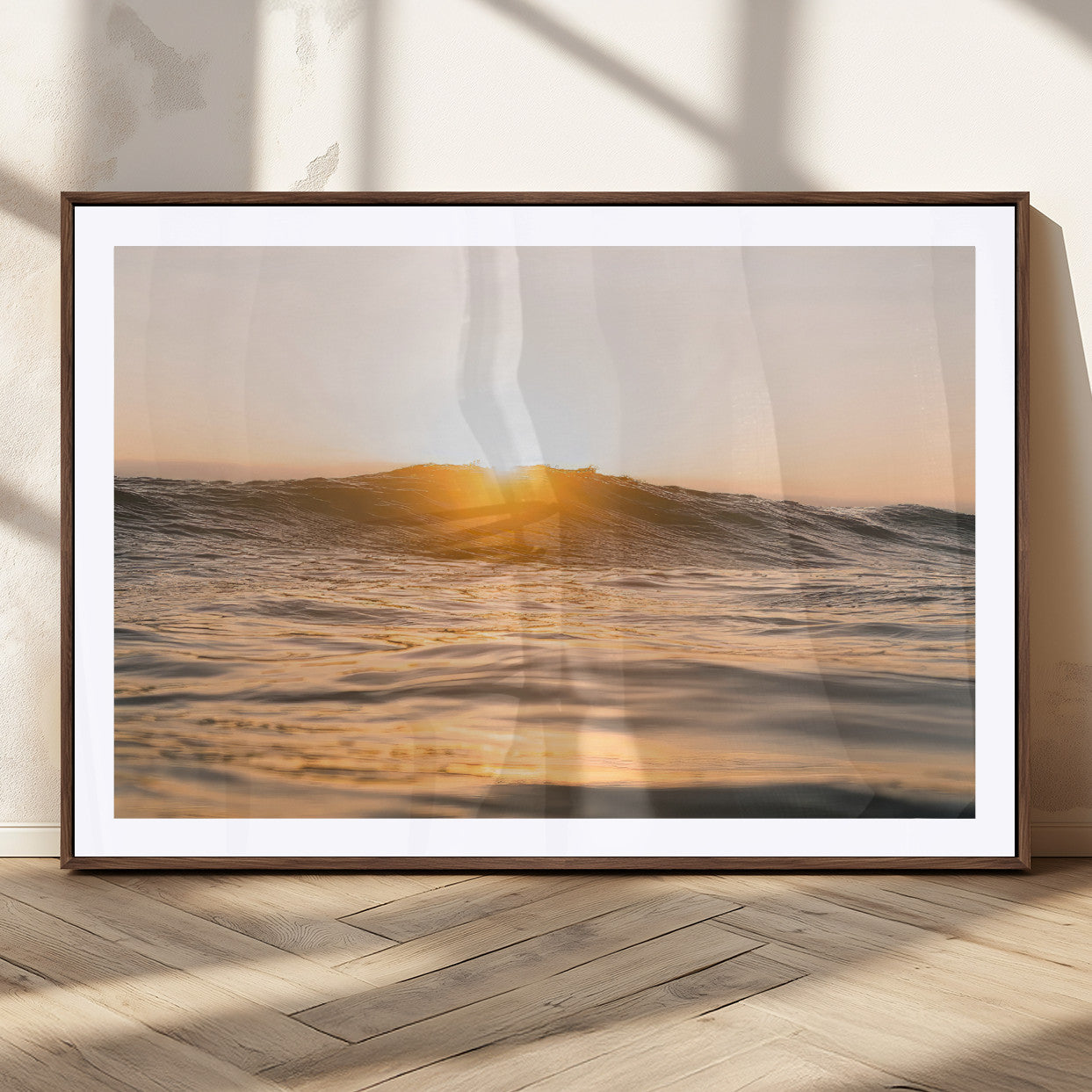 Ocean waves glowing under a warm golden sunset, reflecting soft light and calm movement, perfect for warm minimalist coastal interiors.