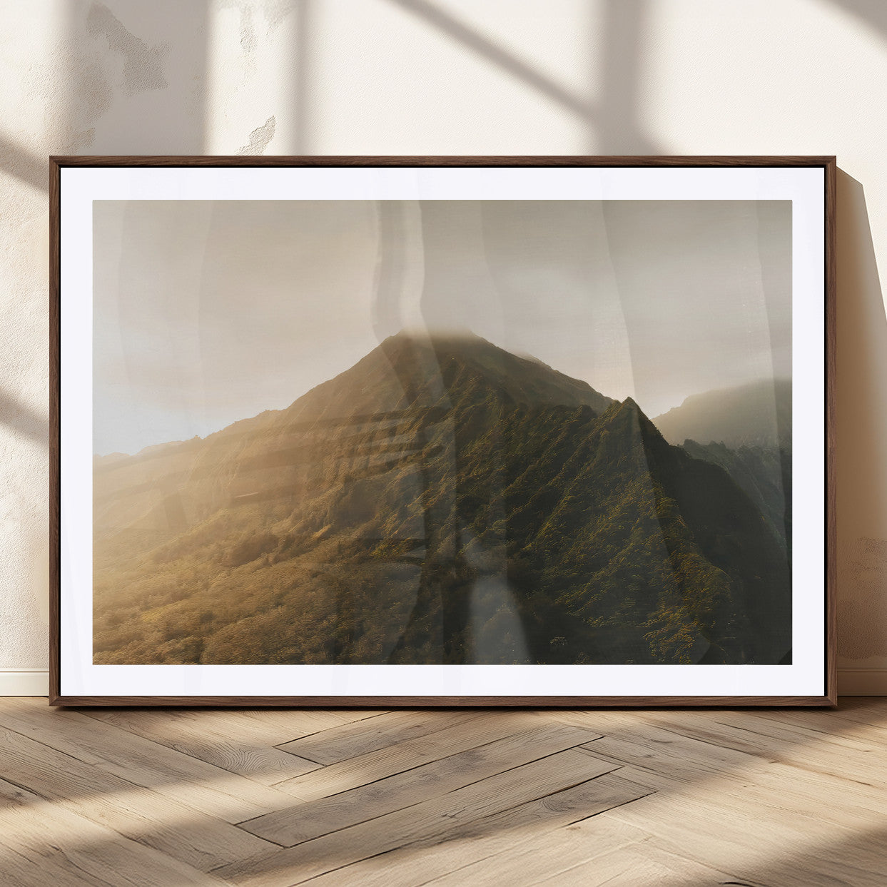 Sunlit mountain peak with mist rolling over its rugged slopes, bathed in golden light, creating a warm and tranquil nature-inspired scene.