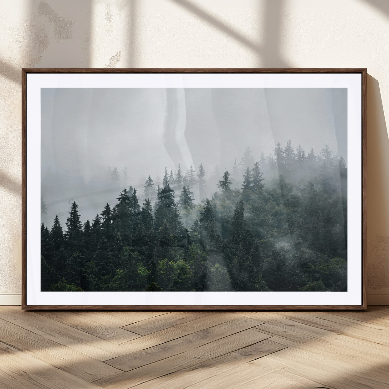 A misty evergreen forest shrouded in soft fog, creating a tranquil and moody landscape with lush green trees fading into the distance.