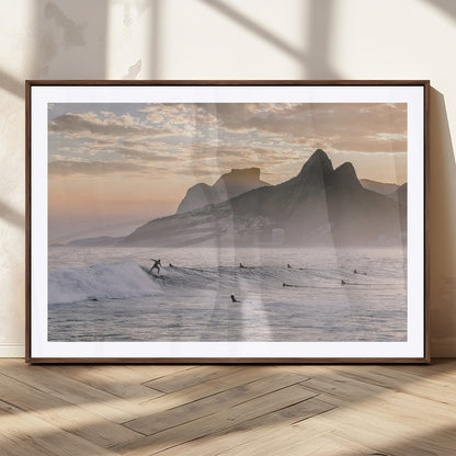A surfer rides a golden hour wave near misty coastal mountains, surrounded by fellow surfers, capturing the spirit of a coastal adventure.