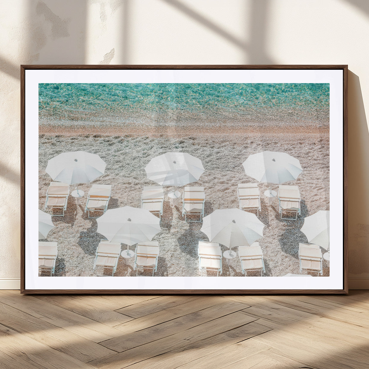 A bright beach scene with white umbrellas, pastel sand, and turquoise waters, creating a tranquil coastal vibe, perfect for beach house or summer decor.