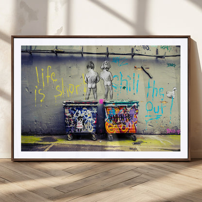 Graffiti-style canvas art with bold text and two naked figures over urban dumpsters, ideal for edgy or street-style decor.