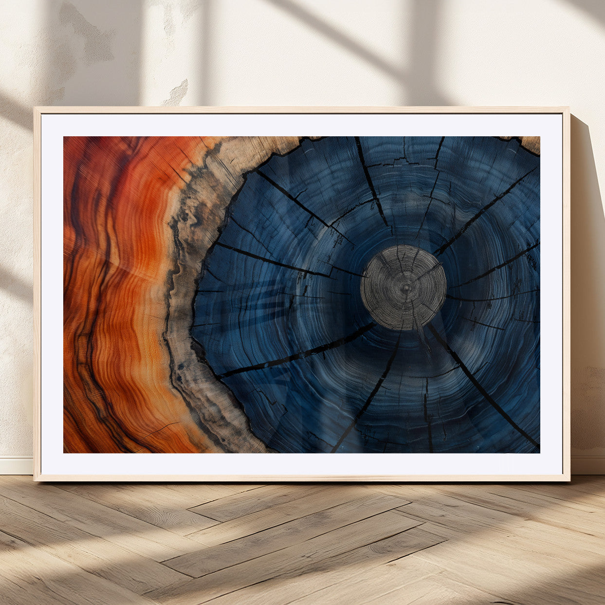 A captivating close-up of a tree trunk, showcasing its concentric rings in rich shades of blue, orange, and brown, highlighting the organic patterns of natural wood.