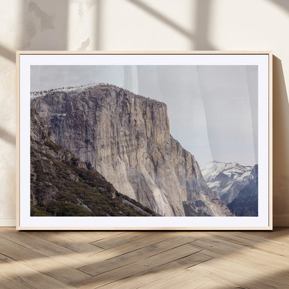 Framed canvas of El Capitan’s vertical granite face in Yosemite with snowy peaks, ideal for Sierra minimalism or mountain-inspired decor.