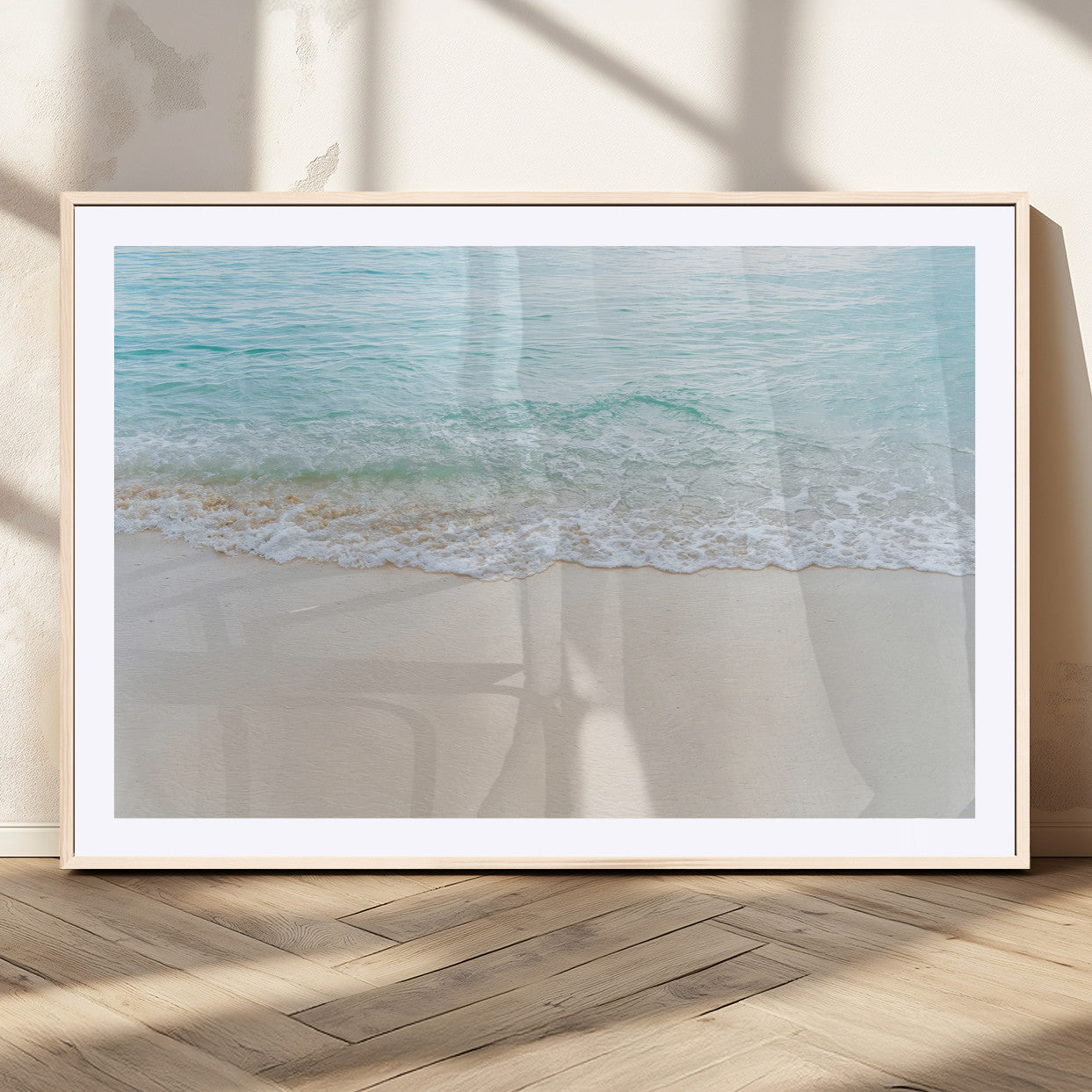 Soft shoreline with gentle aqua waves on smooth sand, ideal for minimalist coastal or pastel ocean-inspired home wall decor.