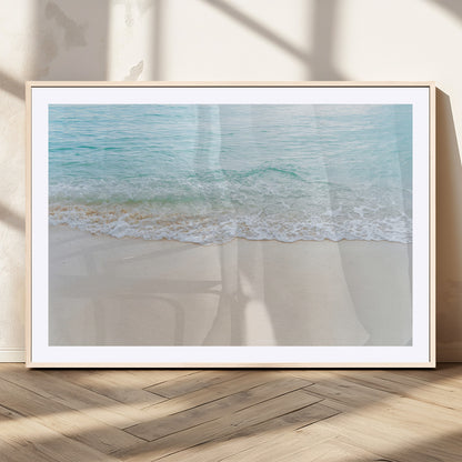 Soft shoreline with gentle aqua waves on smooth sand, ideal for minimalist coastal or pastel ocean-inspired home wall decor.