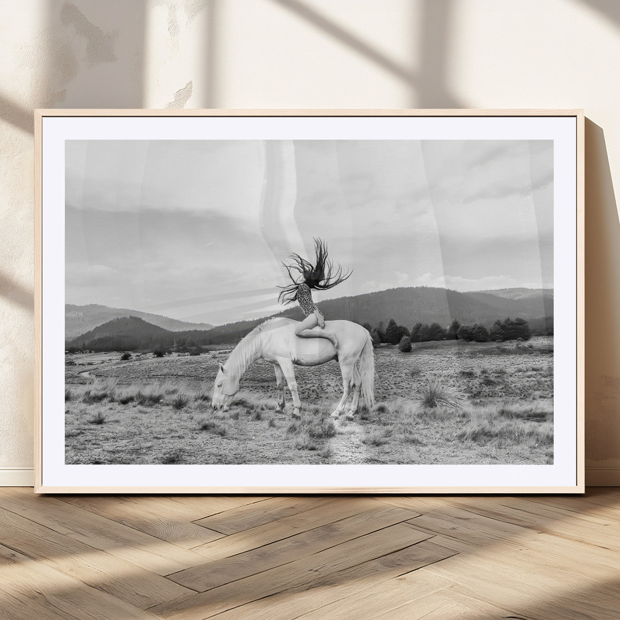 Black and white photo of a woman on a white horse in moody tones, ideal for Western Boho or modern rustic-style home decor.