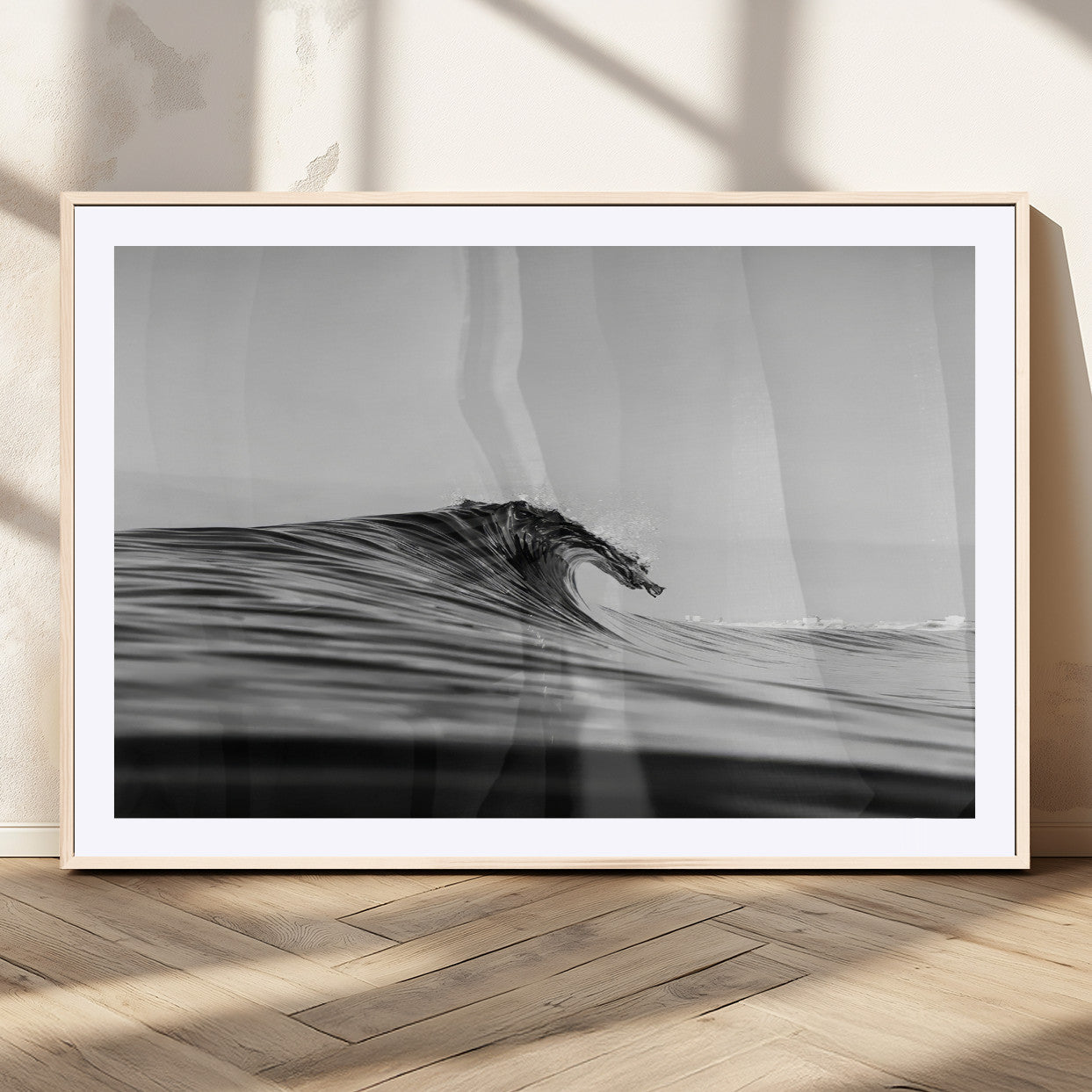 Striking black and white photo of a curling wave, ideal for modern coastal or minimalist wall decor settings.