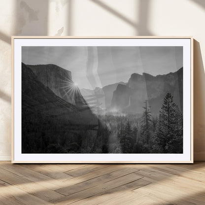 Black and white landscape of Yosemite with sun rays peeking over El Capitan, ideal for moody nature or modern rustic decor.