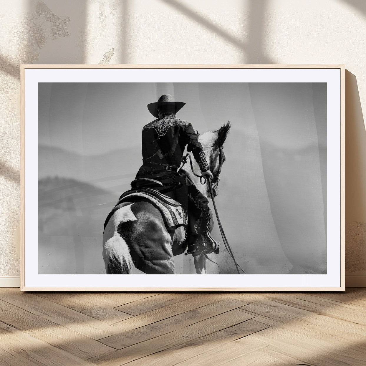 Black and white canvas of a cowboy on horseback with moody tones, perfect for rustic western or country-inspired home decor.