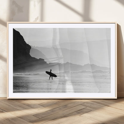 A lone surfer walking along a misty beach with cliffs in the background, carrying their board, capturing a serene and minimal ocean moment.