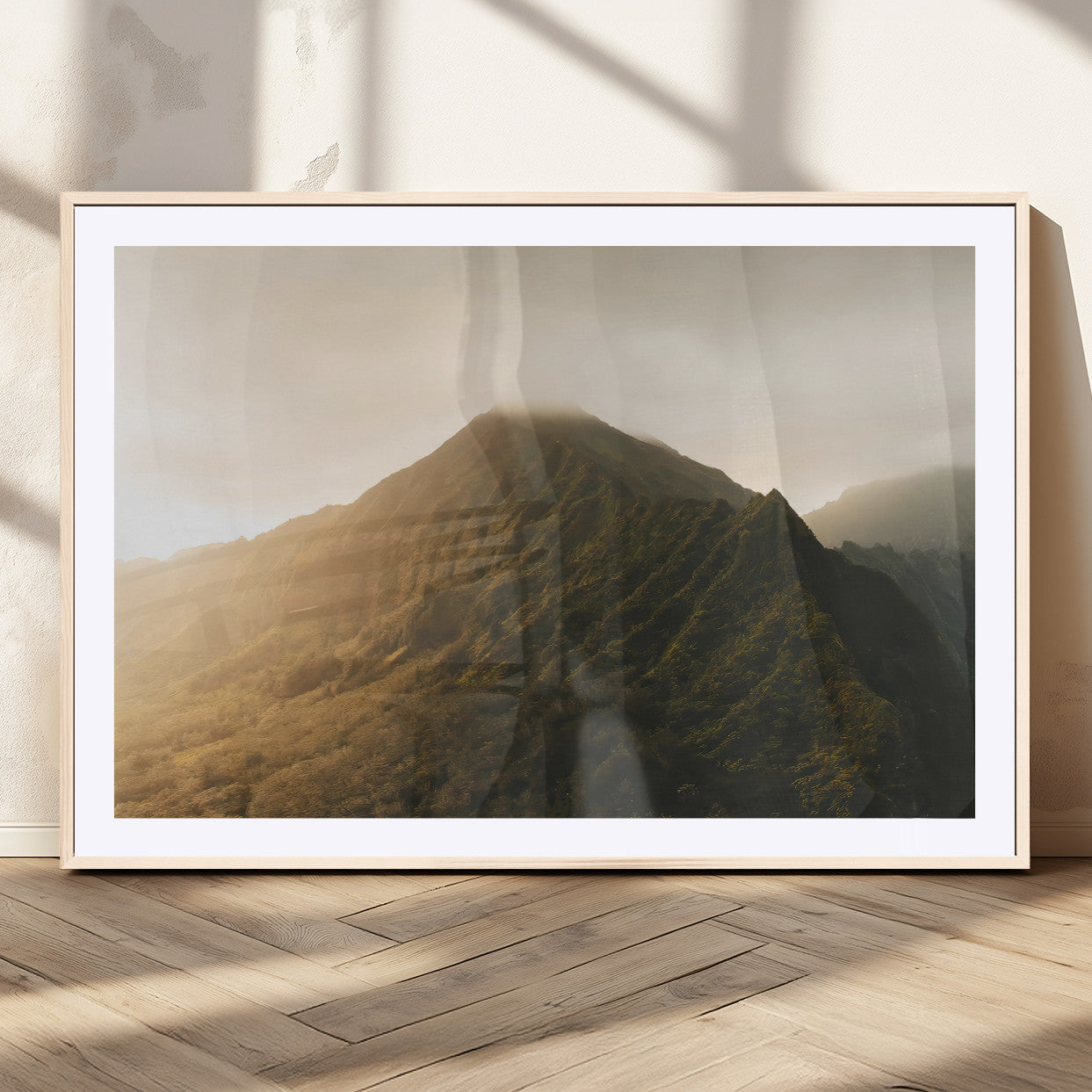Sunlit mountain peak with mist rolling over its rugged slopes, bathed in golden light, creating a warm and tranquil nature-inspired scene.