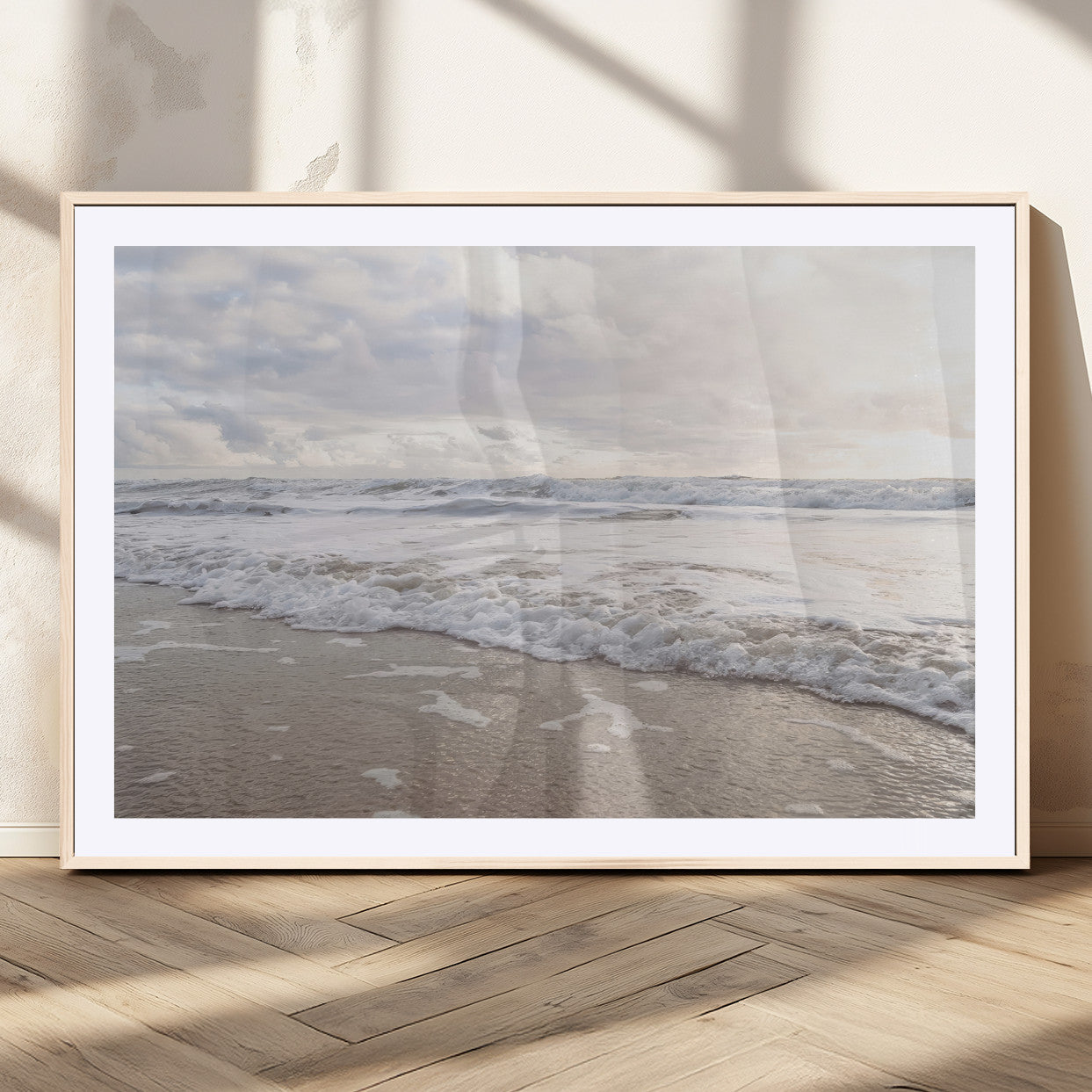 Peaceful ocean waves rolling onto the sandy shore under soft light, perfect for neutral or coastal minimalist decor themes.