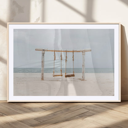 A rustic wooden beach swing stands on a serene sandy shore with an ocean horizon in the background, creating a tranquil and dreamy coastal escape.