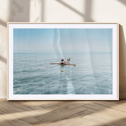 A peaceful minimalist scene of a person floating on crystal-clear water, surrounded by a vast open horizon, capturing relaxation and serenity in a tranquil aquatic setting.