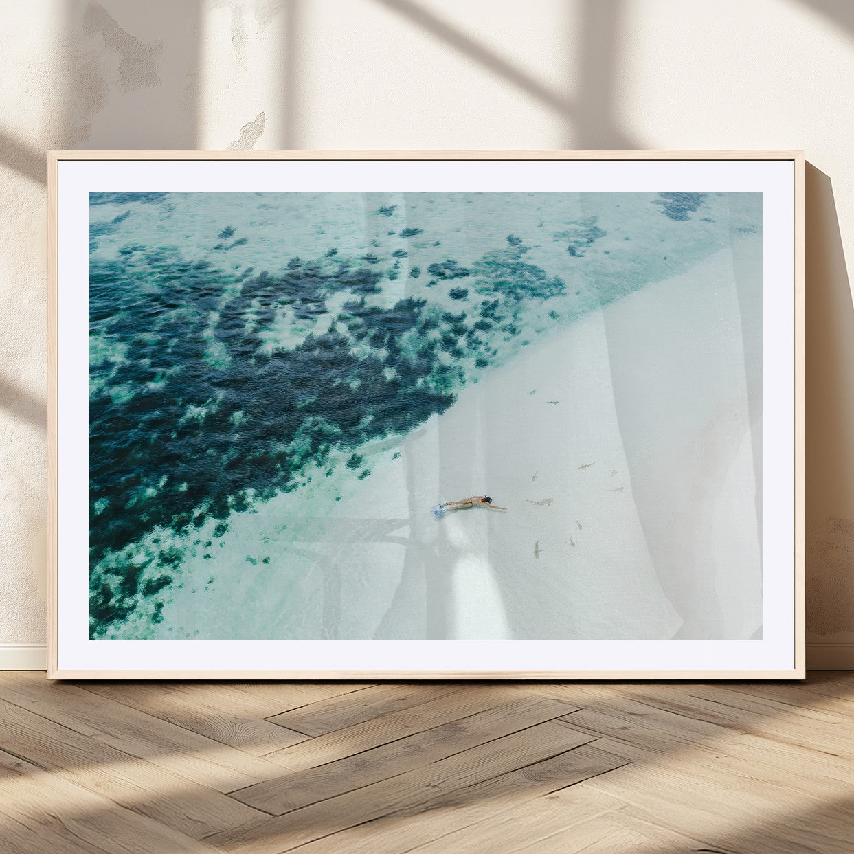 Canvas featuring an aerial view of a swimmer in shallow turquoise waters with coral patterns, ideal for tropical coastal home decor.