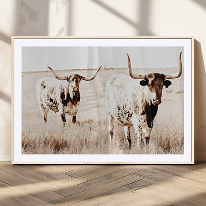 Two Texas longhorn cows standing in a sepia-toned pasture, evoking rustic charm perfect for farmhouse or western country interiors. (