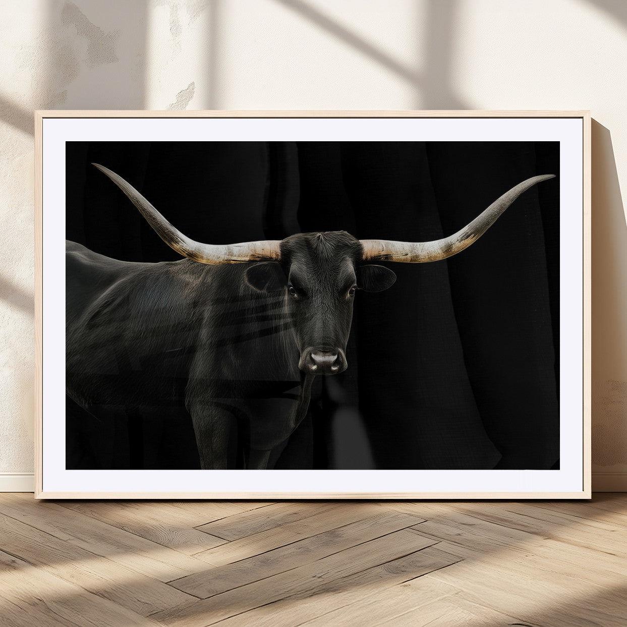 Close-up of a black Texas longhorn with large curved horns on black background, ideal for rustic farmhouse or modern western interiors.