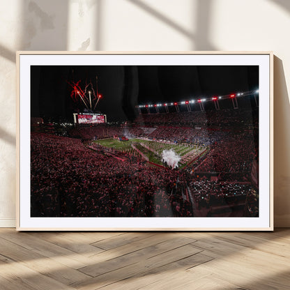 A dramatic shot of a packed stadium at night, with fireworks and smoke creating an exciting atmosphere for a live football game.