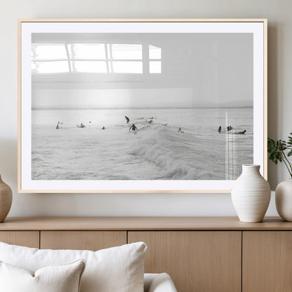 Monochrome photo of surfers riding and waiting on ocean waves, ideal for surf-themed or coastal energy wall decor.