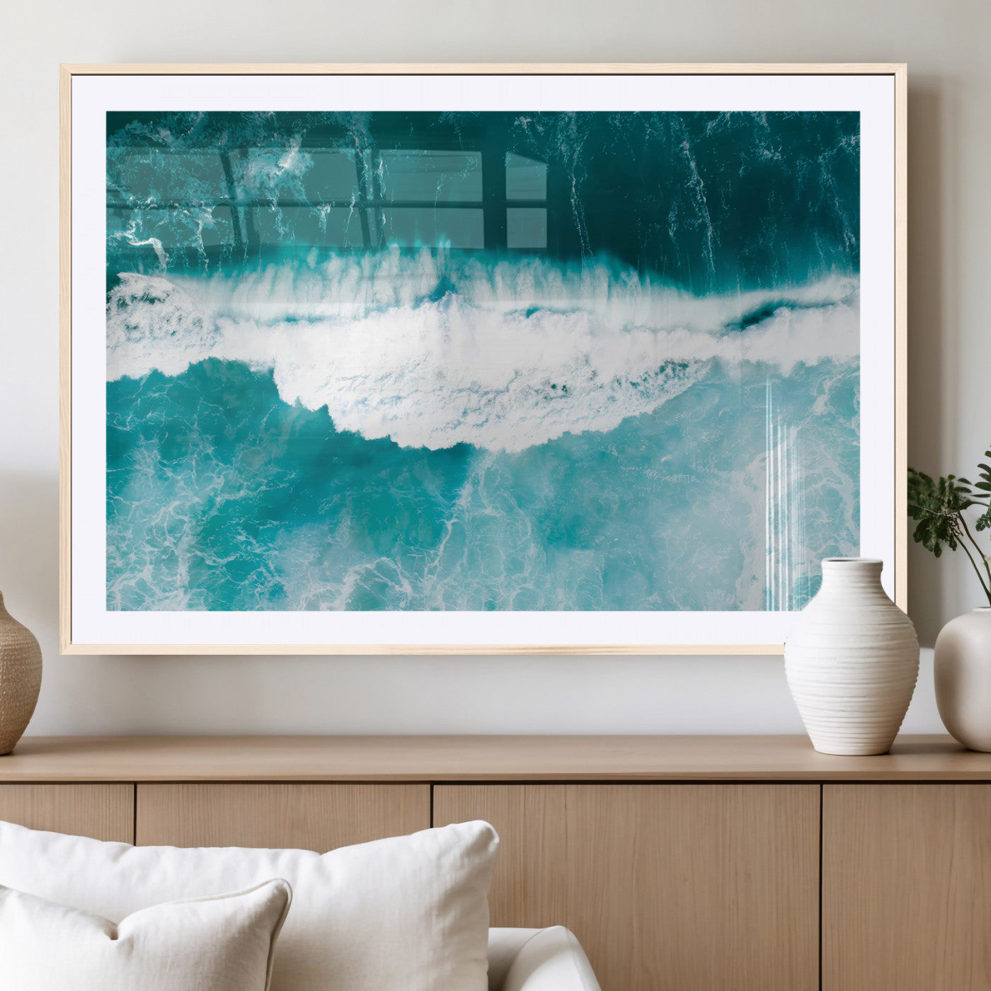 Aerial view of turquoise ocean waves crashing with white foam, perfect for tropical coastal or modern beach-style home decor.