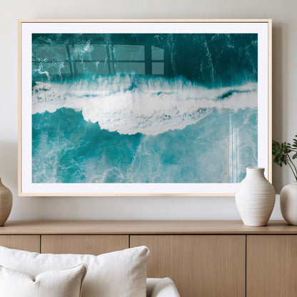 Aerial view of turquoise ocean waves crashing with white foam, perfect for tropical coastal or modern beach-style home decor.