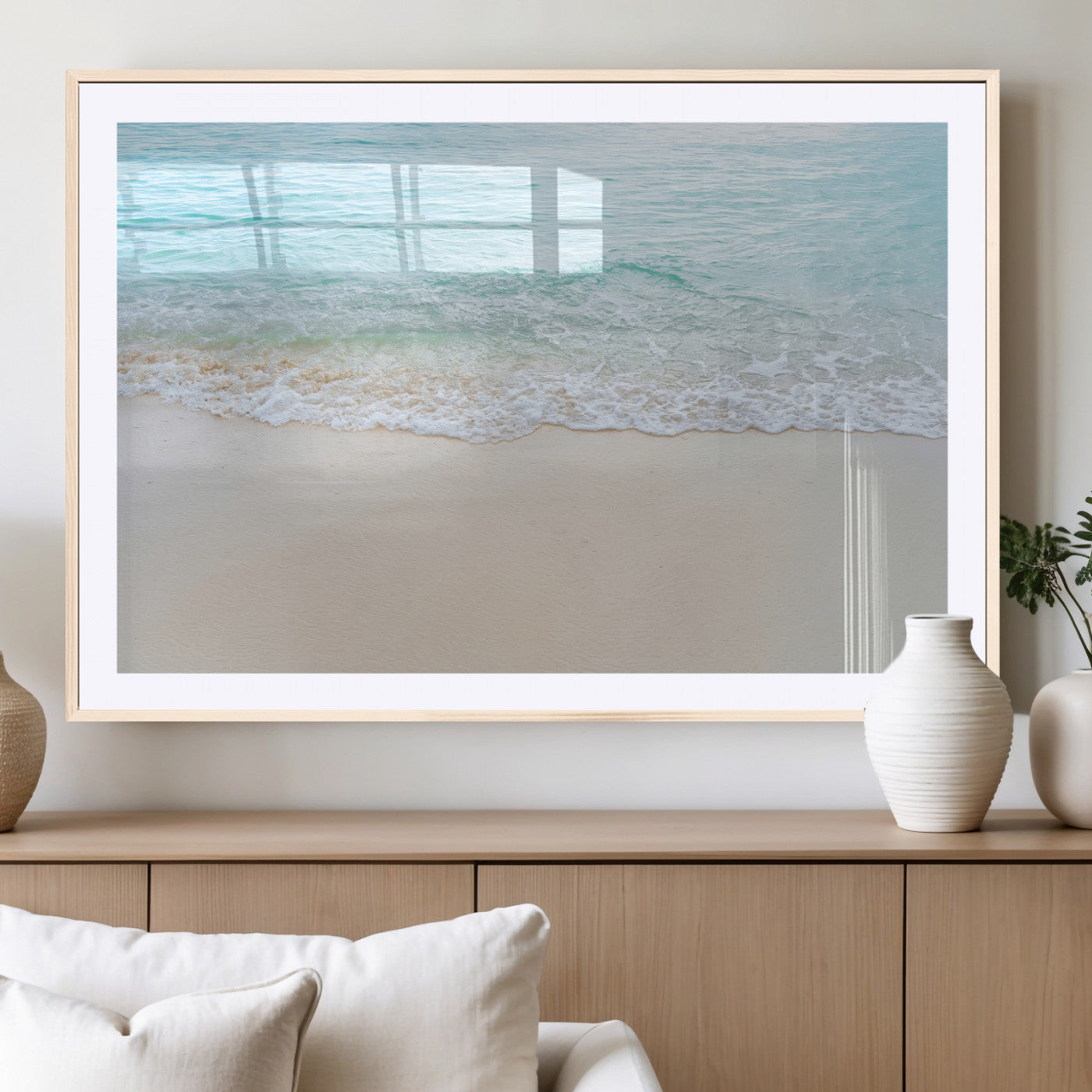 Soft shoreline with gentle aqua waves on smooth sand, ideal for minimalist coastal or pastel ocean-inspired home wall decor.