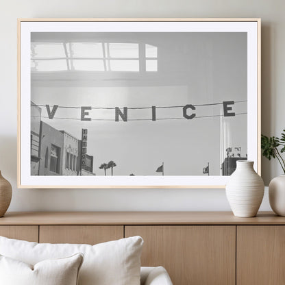 Black and white photo of Venice Beach sign and palm-lined street, perfect for urban coastal or minimalist LA-inspired wall decoration.