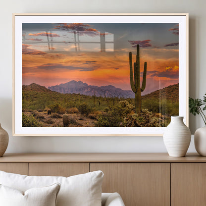 Vibrant desert sunset with saguaro cacti and distant mountains, perfect for Southwestern or warm-toned home decor.