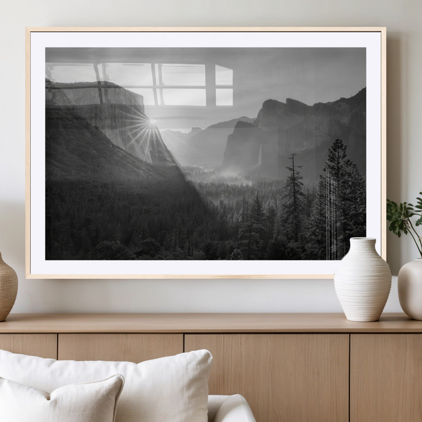 Black and white landscape of Yosemite with sun rays peeking over El Capitan, ideal for moody nature or modern rustic decor.