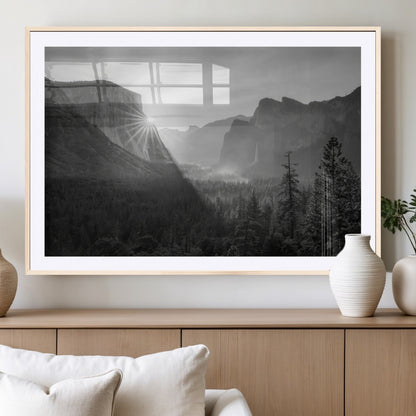 Black and white landscape of Yosemite with sun rays peeking over El Capitan, ideal for moody nature or modern rustic decor.