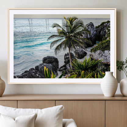 Framed canvas of a vibrant tropical coastline with palm trees, rocky cliffs, and turquoise waters, ideal for tropical coastal home decor.