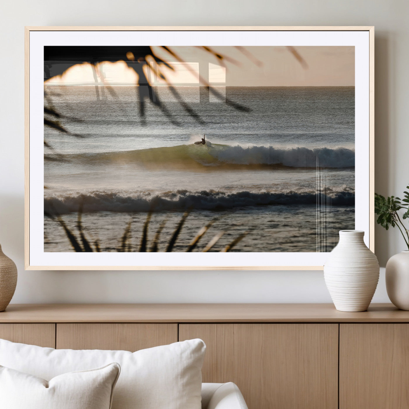 Photo of a surfer riding a golden hour wave at sunset, with tropical tones and dreamy light, perfect for tropical boho or coastal home decor.
