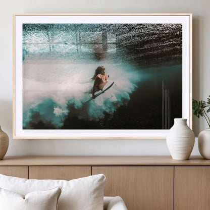 Vibrant underwater photo of a female surfer diving through turquoise waves, perfect for coastal boho or surf-inspired home decor.