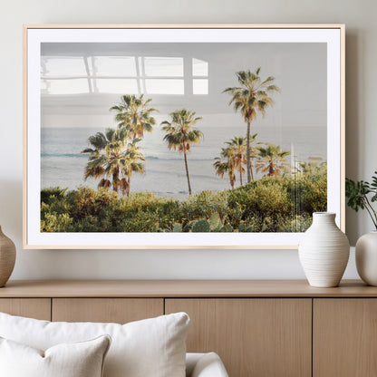 Framed print of sunlit palm trees on the California coast with warm tones, perfect for coastal minimalist or beach-style home decor.