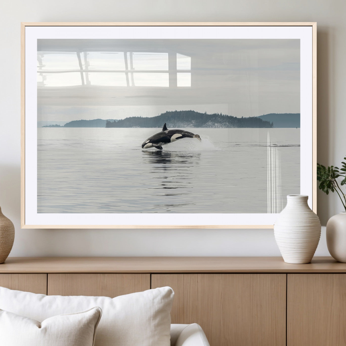 An orca jumping out of calm ocean waters with a misty island in the background, creating a serene and minimalist marine wildlife scene.