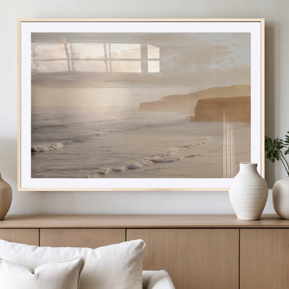 Golden hour seascape with misty cliffs and gentle waves rolling towards the shore, capturing a tranquil and warm coastal atmosphere.