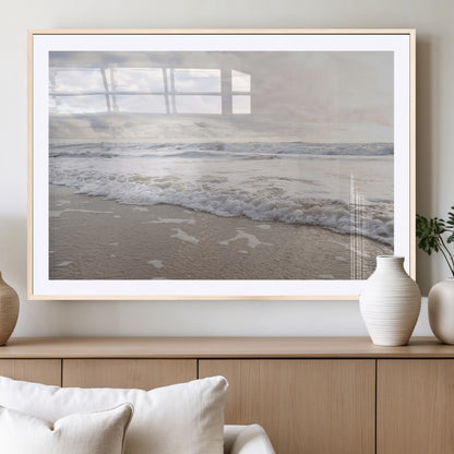 Peaceful ocean waves rolling onto the sandy shore under soft light, perfect for neutral or coastal minimalist decor themes.