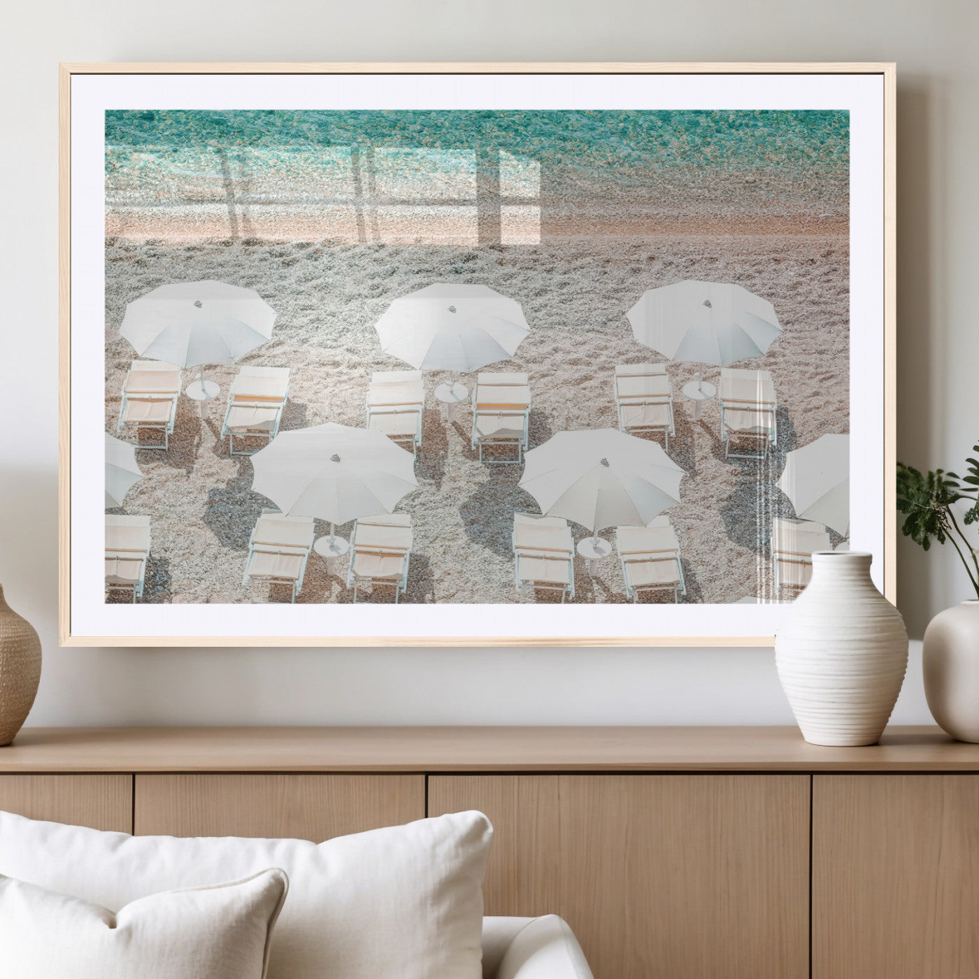 A bright beach scene with white umbrellas, pastel sand, and turquoise waters, creating a tranquil coastal vibe, perfect for beach house or summer decor.