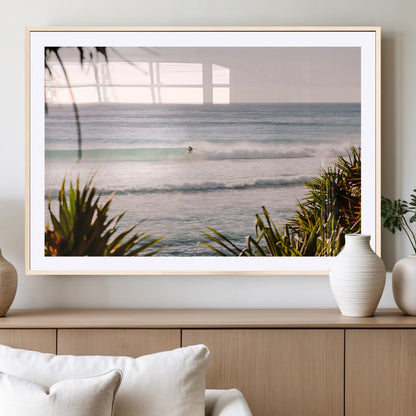 Canvas of a lone surfer riding a pastel wave at sunrise, perfect for tropical or coastal-themed spaces with a relaxed, airy vibe.