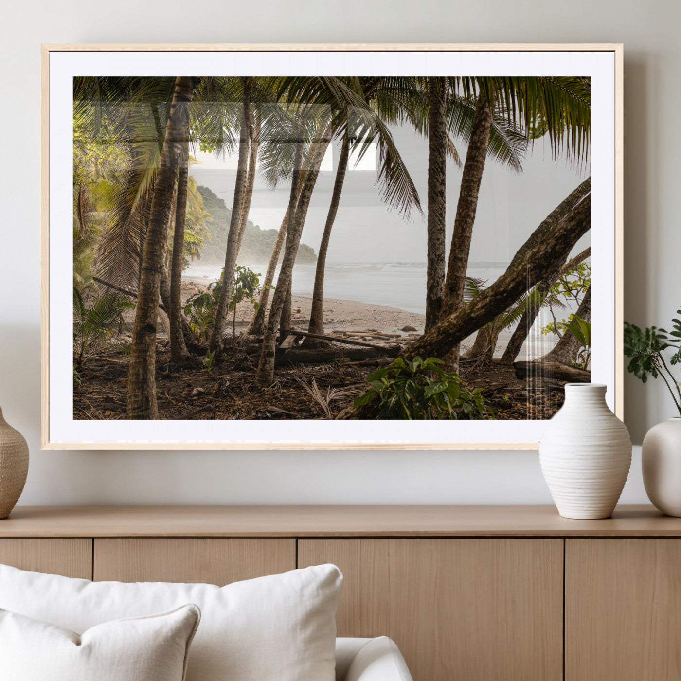 Dense tropical palm trees framing a sandy beach and ocean shore, ideal for jungle or coastal themed interior wall decor.