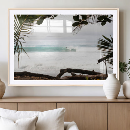 Tropical beach view with palm trees and surfer riding a wave, perfect for boho or coastal-inspired interior wall decor.