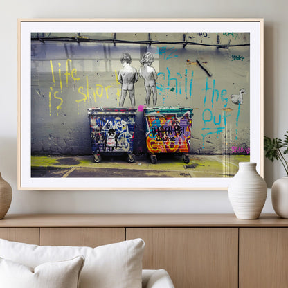 Graffiti-style canvas art with bold text and two naked figures over urban dumpsters, ideal for edgy or street-style decor.