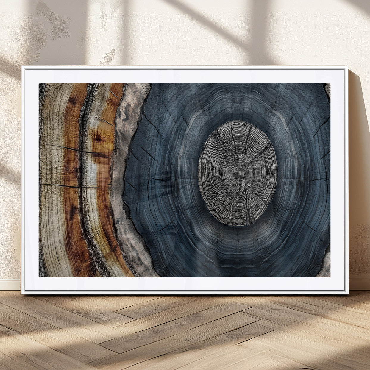 A stunning close-up of a tree trunk showing the intricate, circular growth rings, showcasing the natural textures and rich contrasts in deep blues, browns, and silvers.