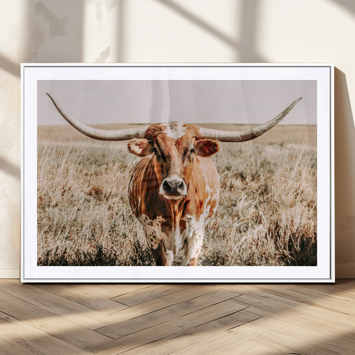 Framed longhorn cow canvas wall art with rustic prairie background, western animal print perfect for farmhouse or ranch style decor